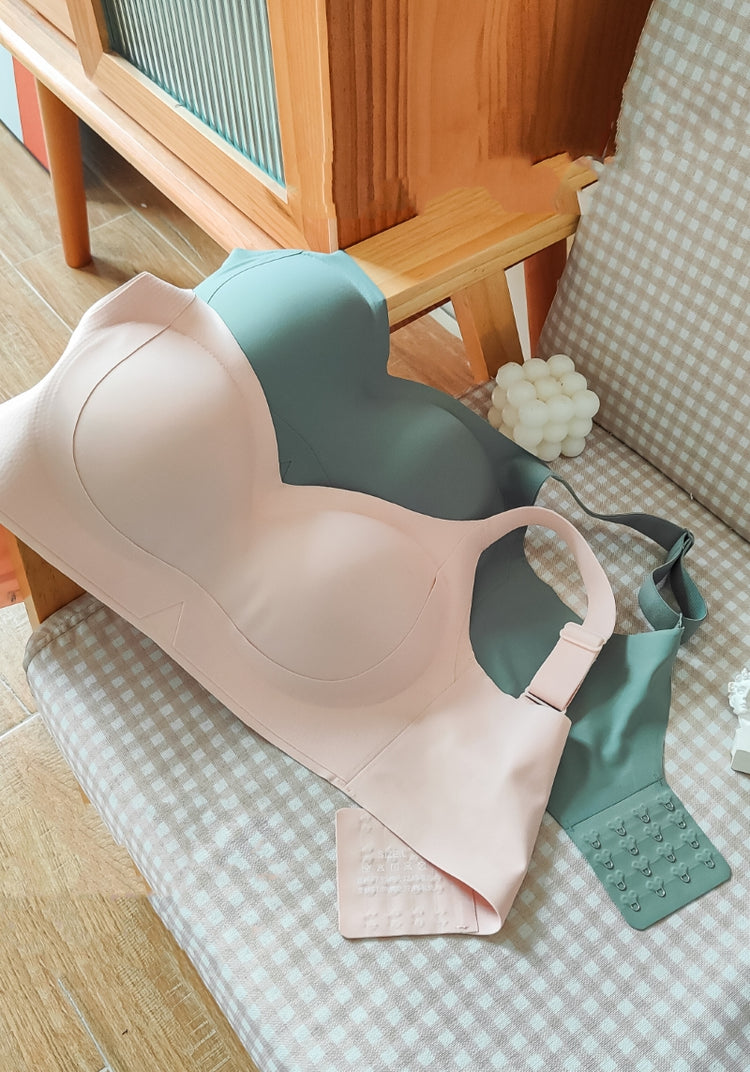 Chic Comfort Bra in beige and green, hung neatly on a wooden arm rest, highlighting its seamless construction and everyday wear suitability.