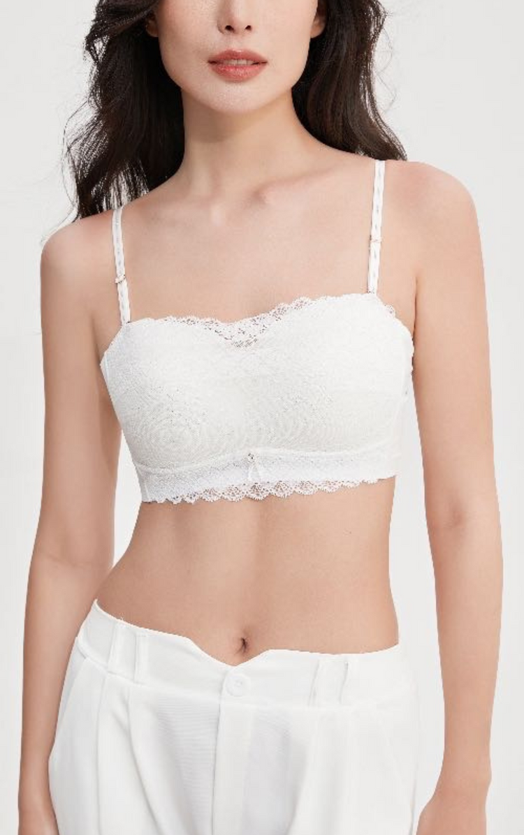 Woman wearing a white Chic Allure Seamless Tube Top Wireless Bralette with detachable shoulder straps and elegant lace design, front view.
