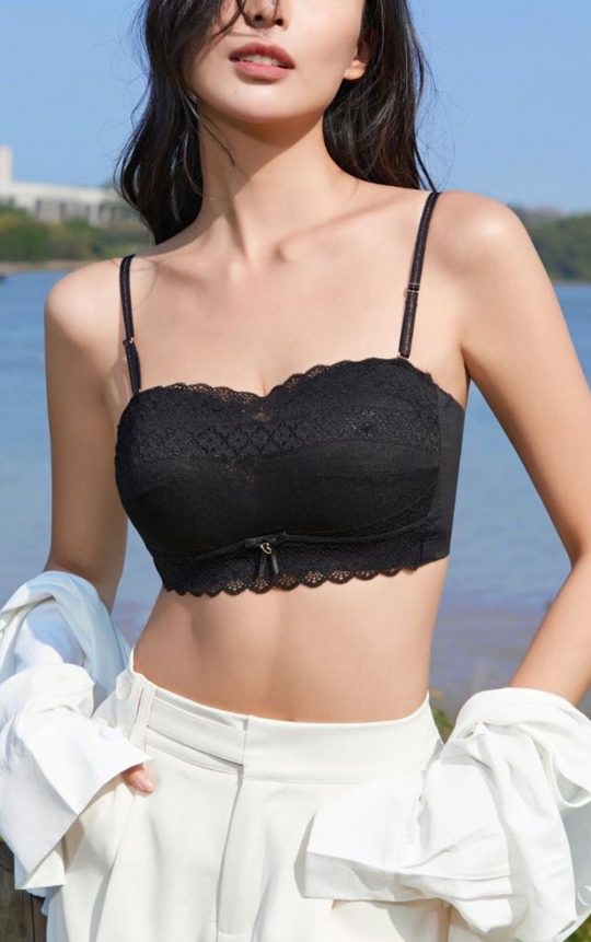 Woman wearing a black Chic Allure Seamless Tube Top Wireless Bralette with detachable shoulder straps and elegant lace design, front view.