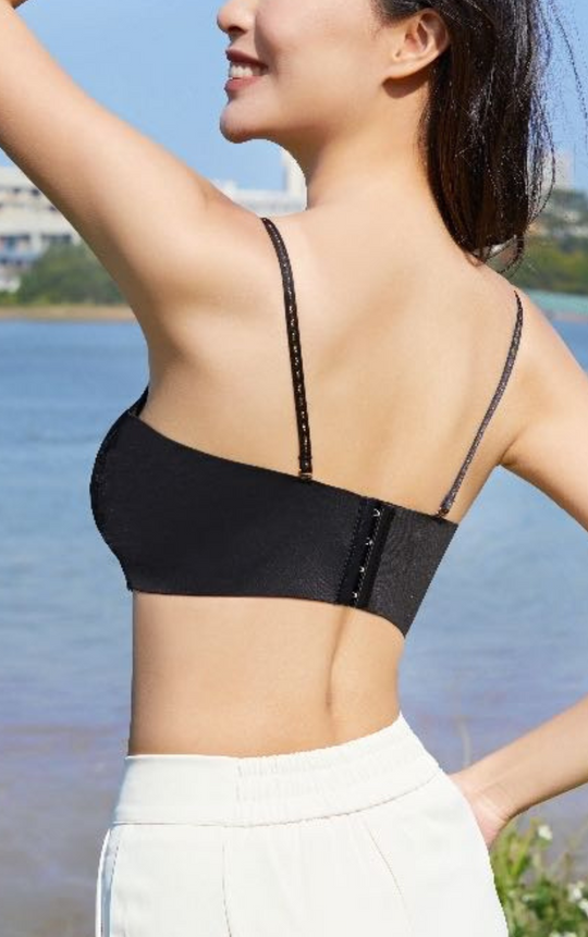 Woman wearing a black Chic Allure Seamless Tube Top Wireless Bralette showing the back design with detachable straps and wide sidebands.