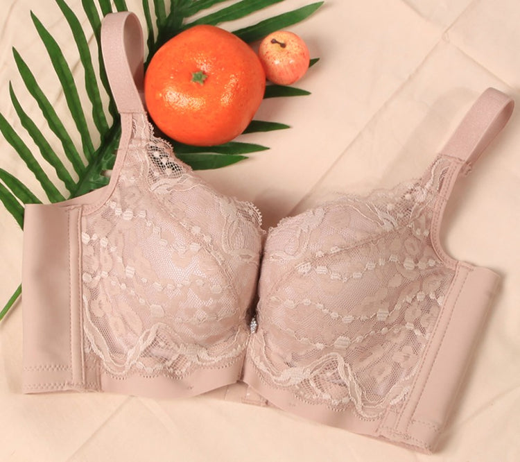 Beige Charming Beauty Intelligent Curve™ Push-Up Bra laid out in a flat lay with tropical accents, showcasing lace details and soft, supportive padding.