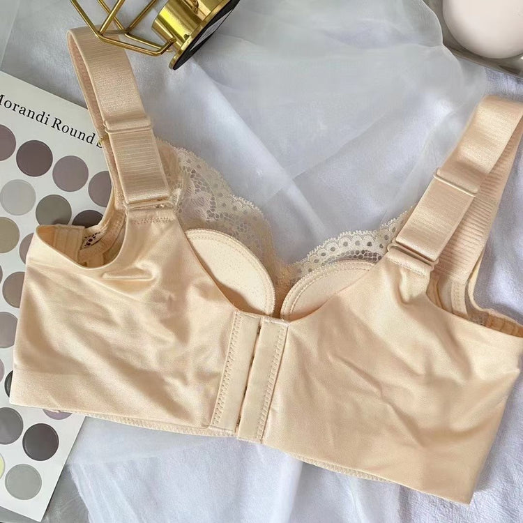 A beige lace bras, showcasing its intricate lace detailing, full coverage cups, and wide supportive straps, laid out for display.