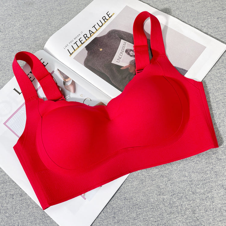 A red wireless bra laid flat, showcasing the structure and wide back smoothing sidebands.