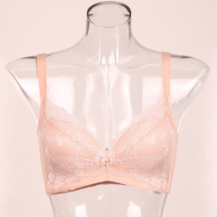 Beige-colored seamless push-up bra with floral lace displayed on a mannequin.