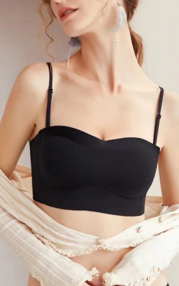 Front view of a woman wearing a black strapless bra, demonstrating the smooth, full coverage support.