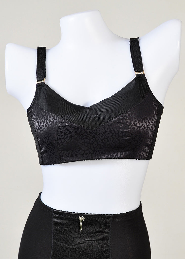 Black bra displayed on a mannequin, highlighting a smooth, seamless design with adjustable straps and a supportive band.