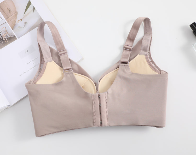 Back view of a pink wireless push-up bra, showing the U-shaped design, adjustable straps, and smooth finish for added support.